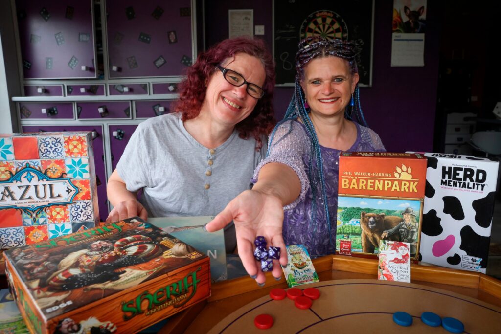 (L- R) Co-founders of Dice and Balls, Zoe Clarke and Saphia Clarke pictured with a selection of games. -- A new boardgame store owned by friends Saphia Clarke and Zoe Clarke, called Dice and Balls is set to open in Arnold town centre. Photo: Wednesday 31st May 2023. (Copyright: Joseph Raynor/ Nottingham Post)