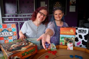 (L- R) Co-founders of Dice and Balls, Zoe Clarke and Saphia Clarke pictured with a selection of games. -- A new boardgame store owned by friends Saphia Clarke and Zoe Clarke, called Dice and Balls is set to open in Arnold town centre. Photo: Wednesday 31st May 2023. (Copyright: Joseph Raynor/ Nottingham Post)