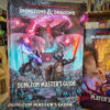 dmg02 Close-up of the Dungeons & Dragons Dungeon Master’s Guide 2024 standard cover featuring epic fantasy artwork with spellcasters and glowing weapons.